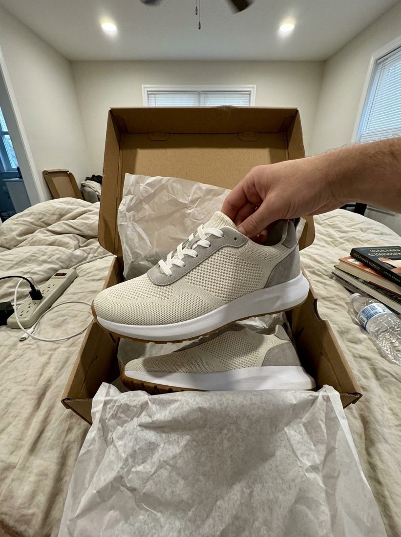 Sneaker unboxing on a bed
